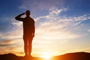 Silhouette of soldier saluting