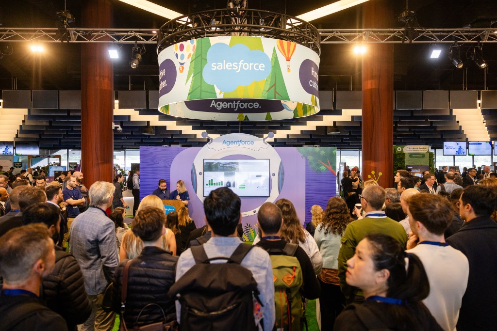 Crowd of people around a demonstration booth at Agentforce Sydney