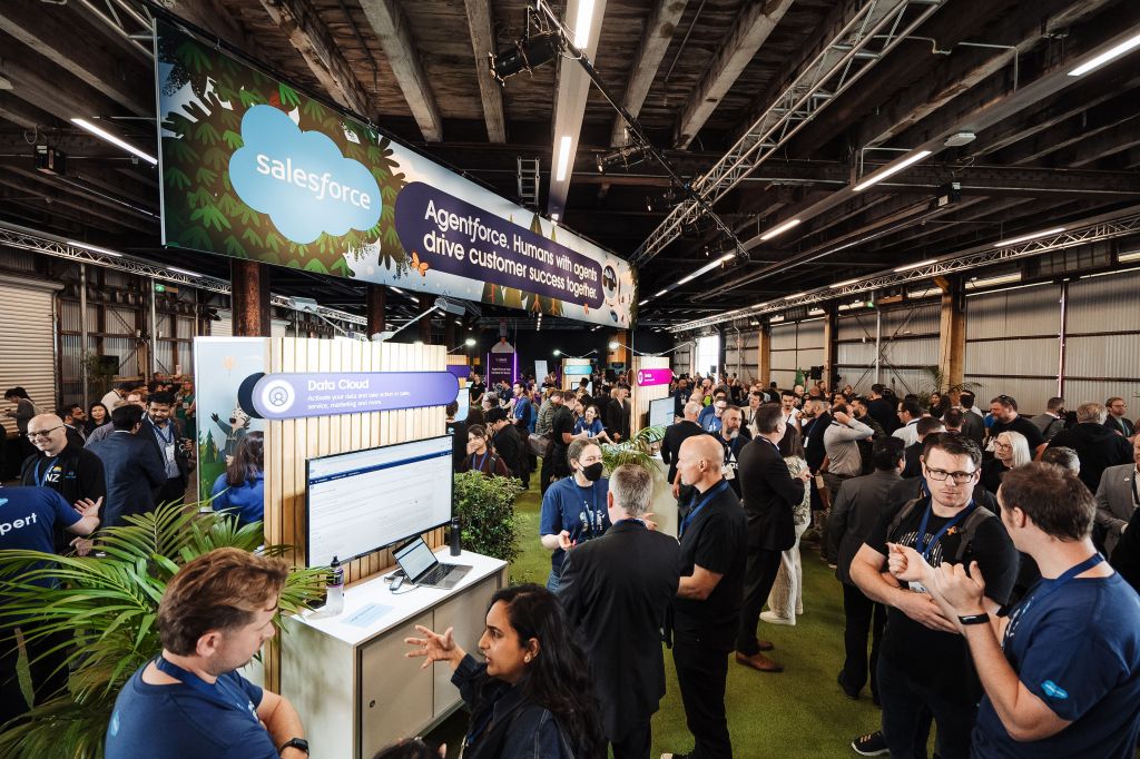 Crowds of people in Shed 10 discussing Salesforce products and demos. 