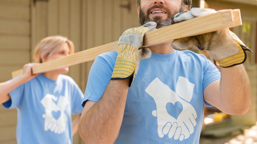 Volunteers carrying wood