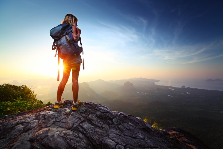 a hiker summiting a mountain