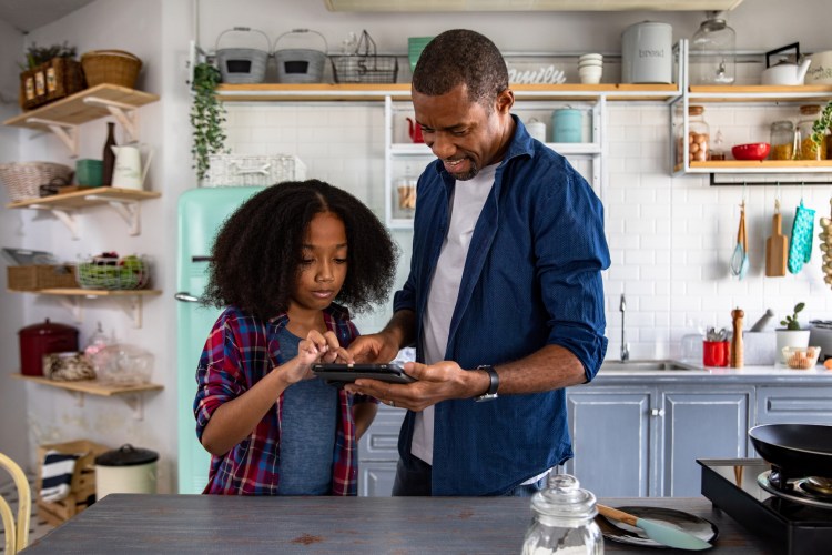 Father and daughter using a tablet