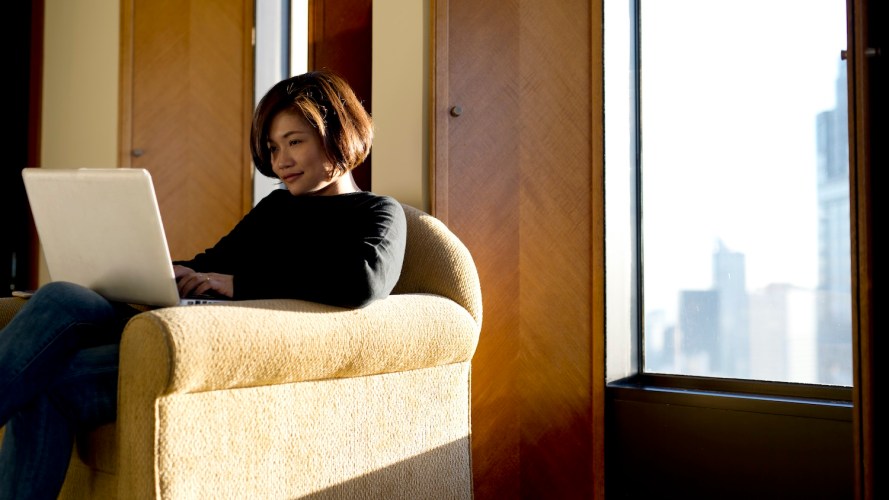 Woman in a chair works on her laptop