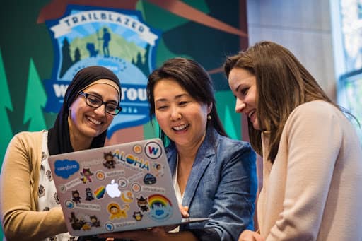 Salesforce employees working on a laptop