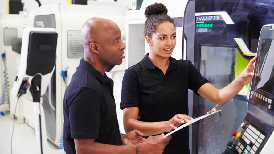 man and woman colleagues looking at a machine automation employee experience