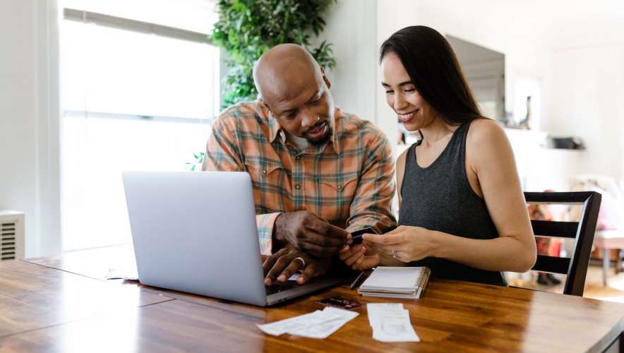 Young couple reviews credit card receipts