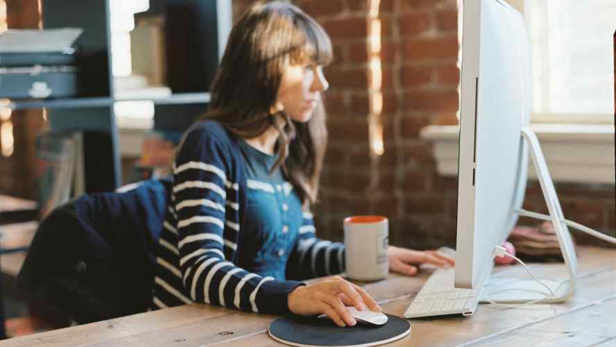 young woman at desktop computer CIO low-code app development