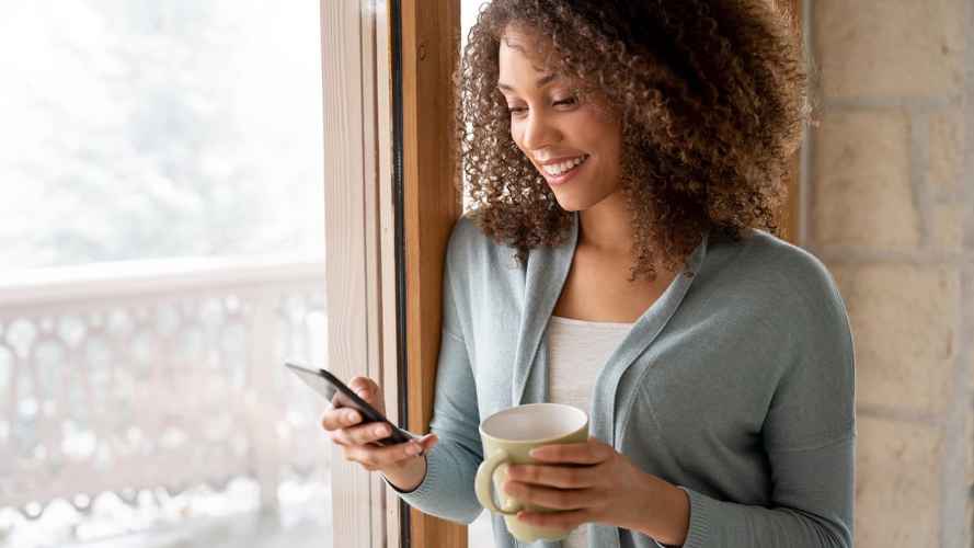 Woman checks her mobile for appointment info