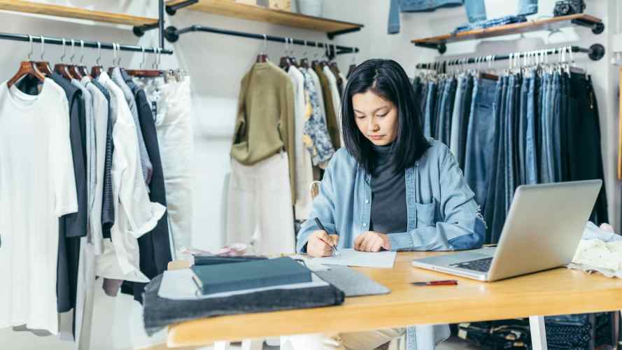 Woman works on her CRM system in a retail store