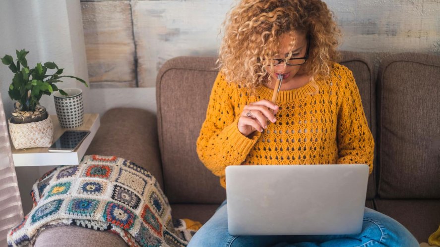 Woman does her keyword research on a laptop