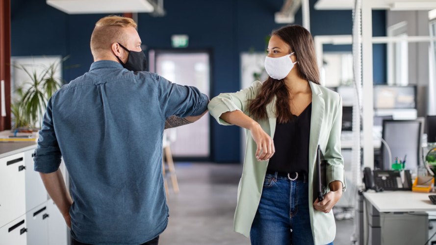 masked people elbow bumping