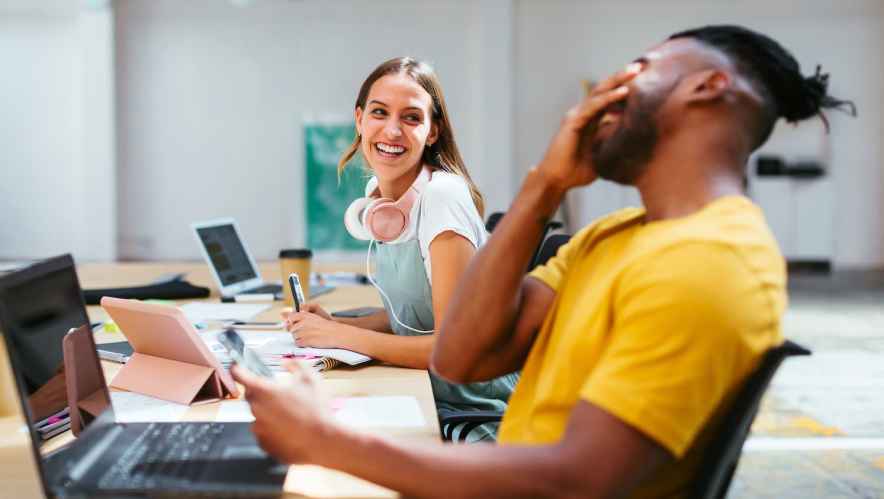 Man and woman laughing at the office