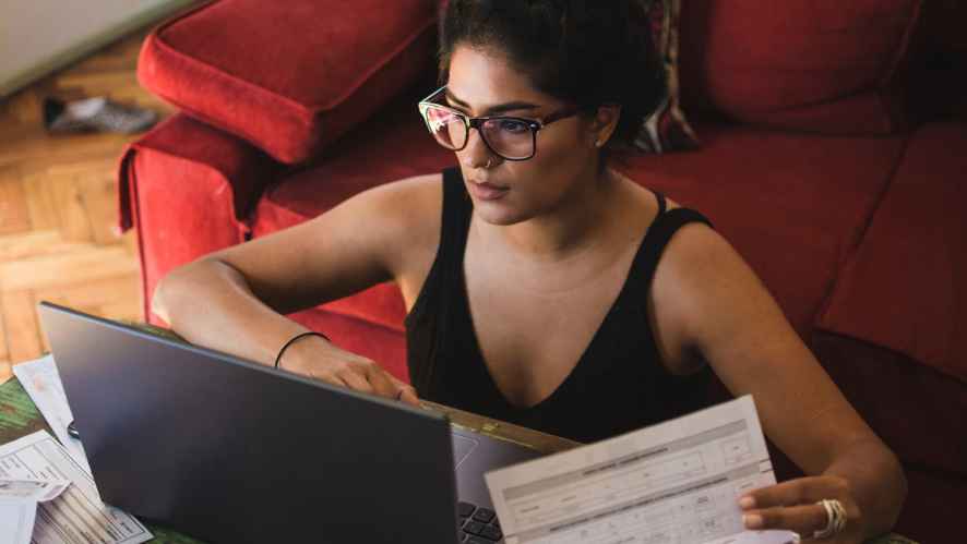 Woman paying bills on her laptop