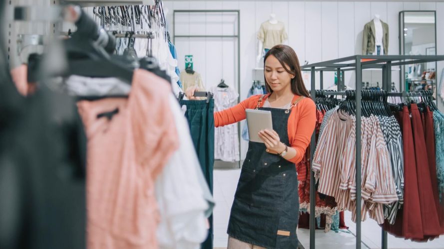 A sales associate views a tablet, a sign of the in-store digital experience.