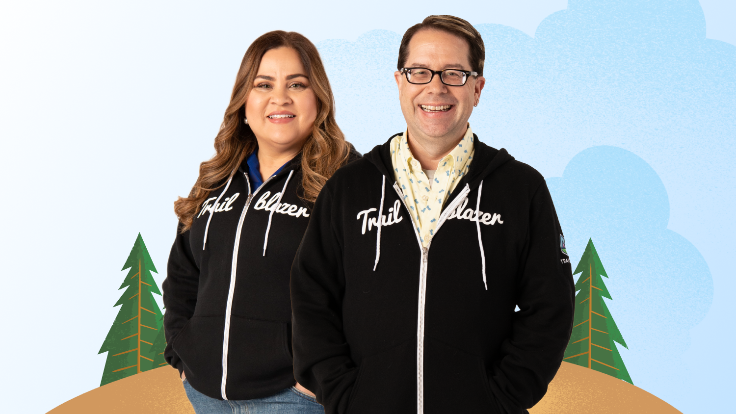 Two Salesforce certified people standing in Trailblazer hoodies