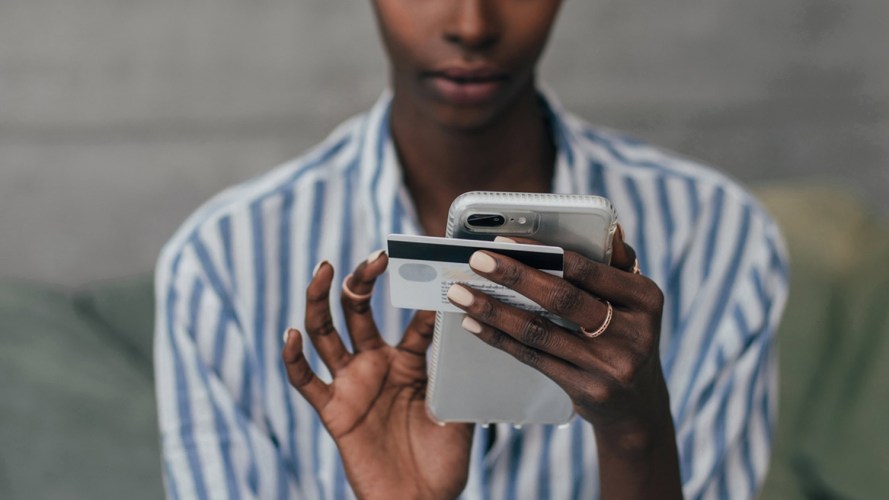 woman holding both her smartphone and credit card: digital process automation