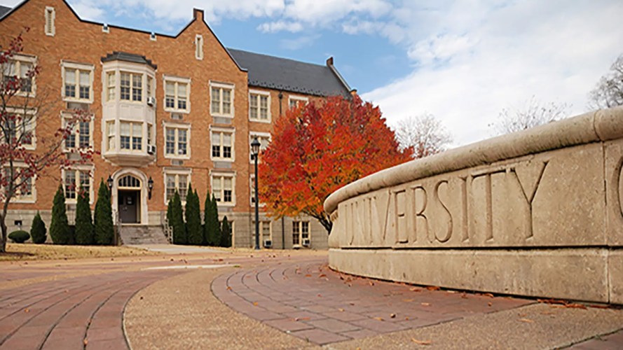 A building and a sign on a university campus