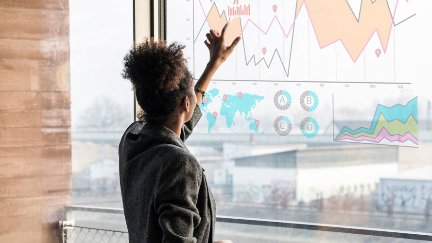 woman looking at a board with graphs and tables: data culture