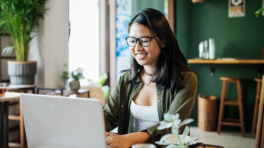 A woman at a laptop at home, perhaps entering customer feedback.