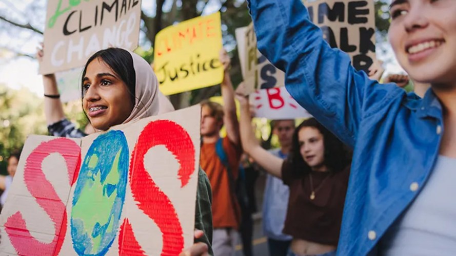 Young people holding up signs to protest climate change