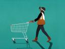 A shopper in trendy attire pushes a white shopping cart: retail data strategy