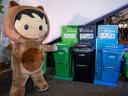 Salesforce's Astro mascot in front of recycling bins