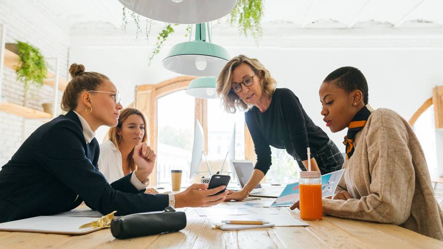 Team of employees discussing marketing trends in a conference room