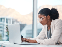 Image of woman on laptop // Protecting Data with the Principle of Least Privilege