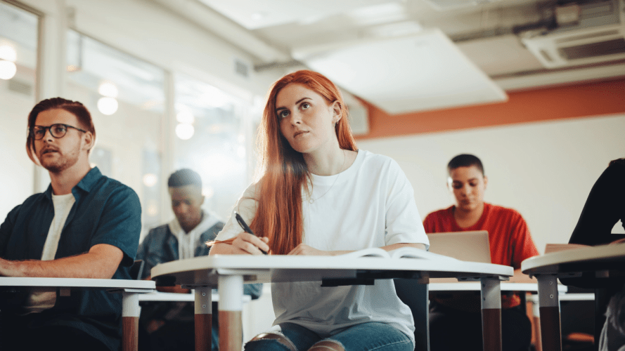 Image of woman studying in a classroom setting / Cybersecurity Learning Hub: Addressing the Global Workforce Gap Through Education