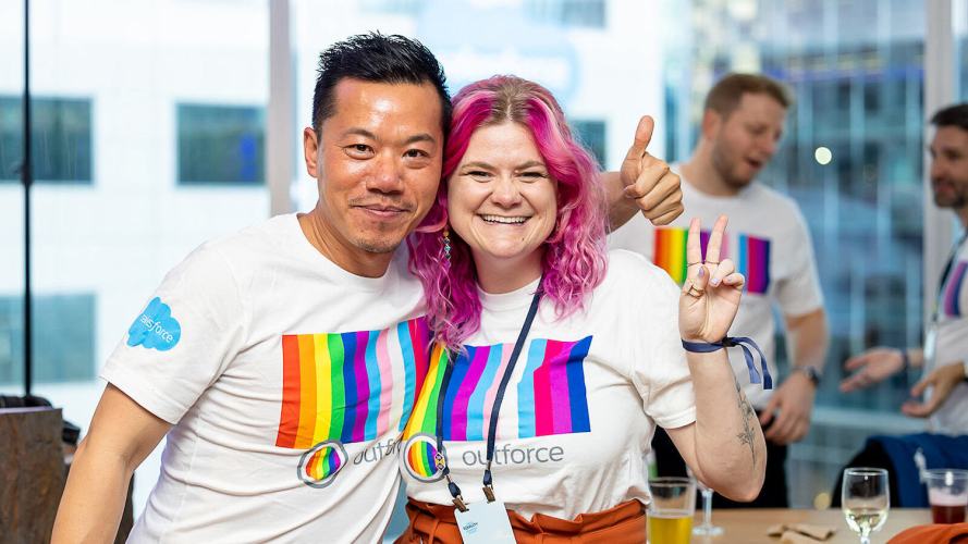 Two people, one making a thumbs-up sign with their hand, and the other, a peace sign: allyship in the workplace