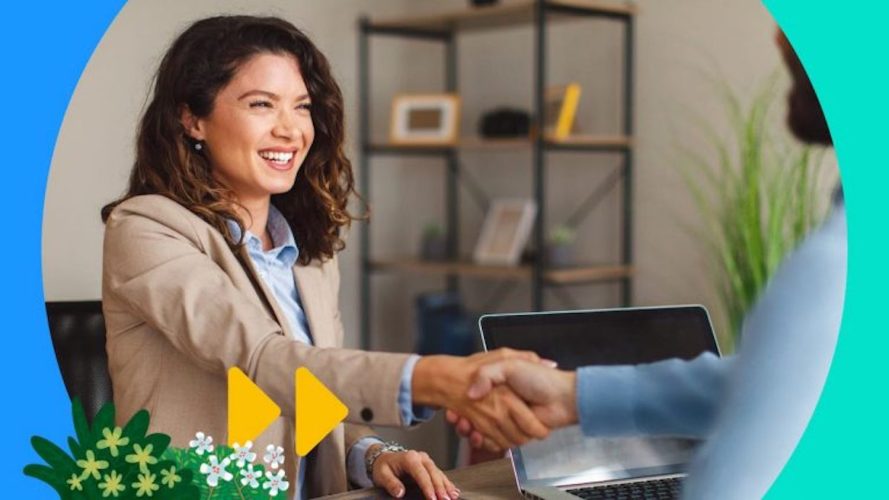 Photo of a woman shaking hands, utilizing sales closing techniques during a sale