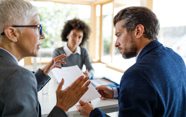 A group of business people discuss AI in the enterprise