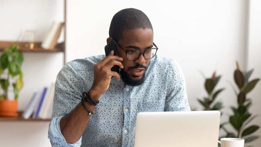 Salesperson on the phone asking questions during a discovery call