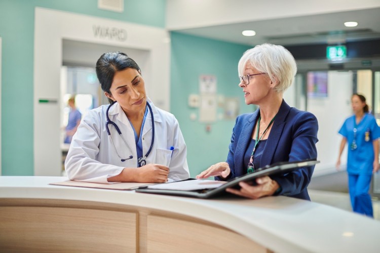 A doctor in a hospital goes over a treatment plan with a female patient / healthcare personalization strategies