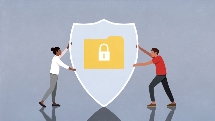 two people holding shield to represent data privacy