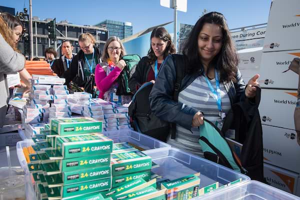 Trailblazers stuffing backpacks with school supplies at Dreamforce.