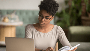 worker studies at a laptop