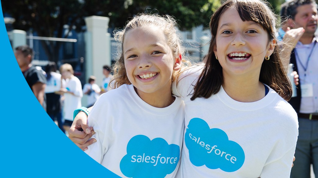 Two students smile at school wearing Salesforce t-shirts