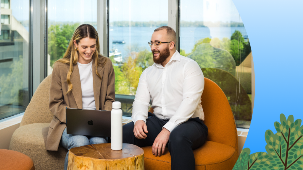 Two salesforce employees chat together on a couch.